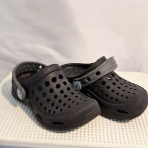 Black Sandals with Perforated Design and Pivoting Heel Strap